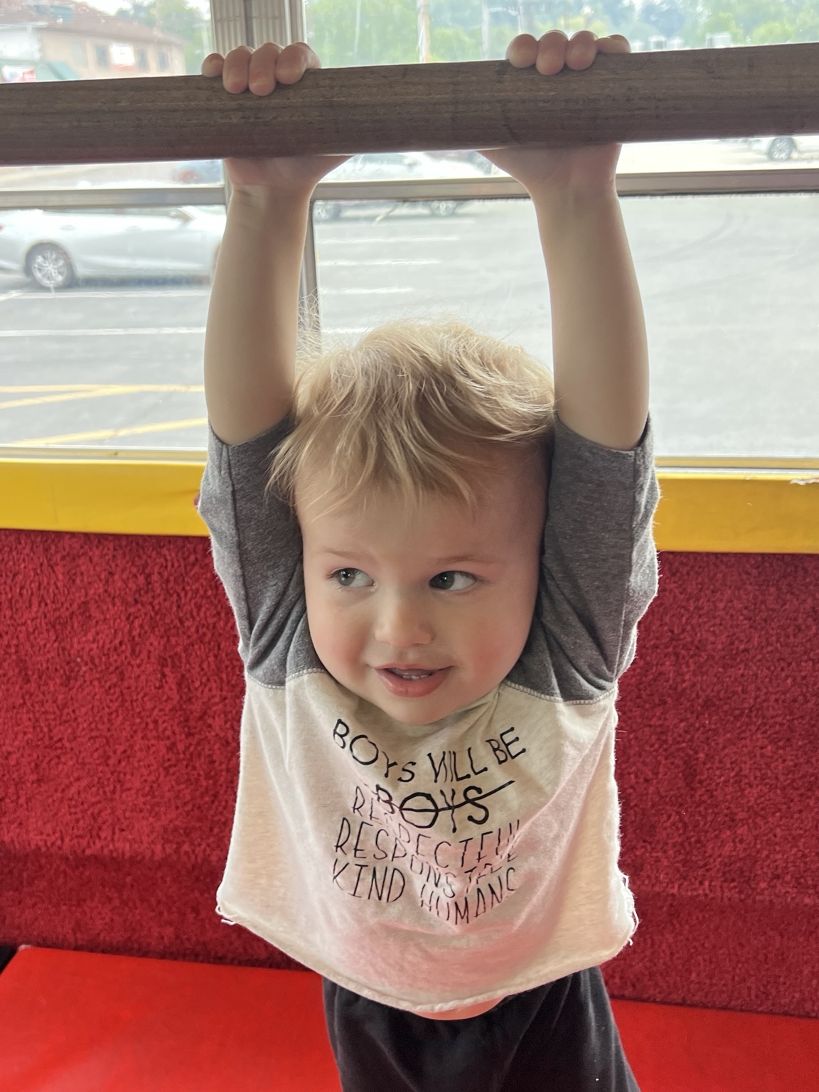 A smiling child playing inside the Tumblebus